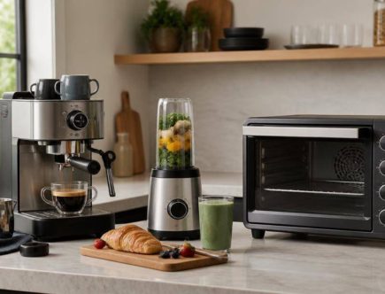 Macchina per il caffè, frullatore e forno compatto disposti su un piano cucina per una prova comparativa.